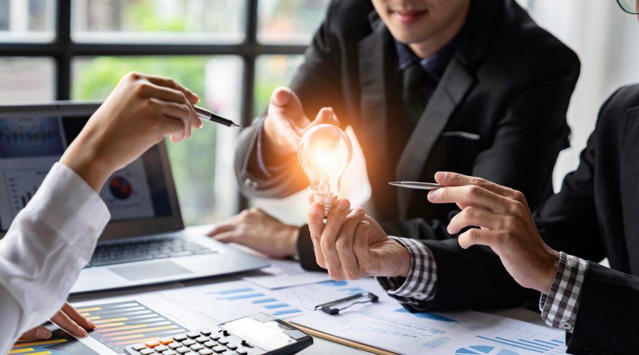 Group,Of,Businessmen,Holding,Light,Bulbs,Brainstorming,Ideas,Finding,New